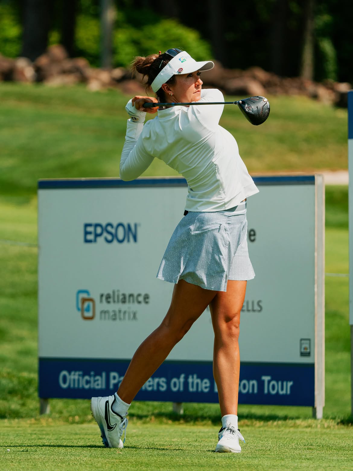 Jillian Hollis following through on a drive off the tee
